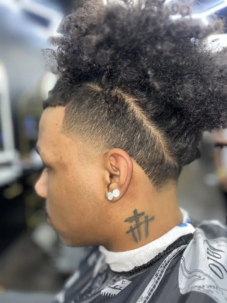 A curly top and a shaved line design, side view