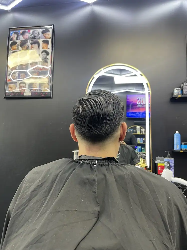 A slicked-back cut, seen from behind